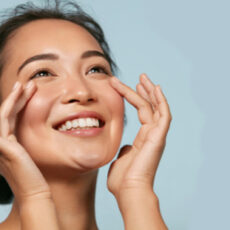 young woman with amazing glowing skin looking up and smiling